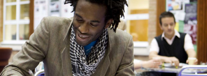 African American student doing homework at the library