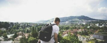 Image of a student with a backpack on campus