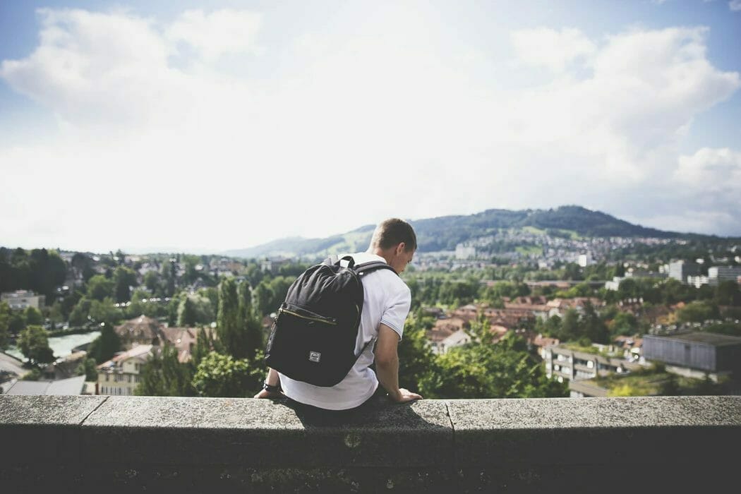 Image of a student with a backpack on campus