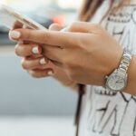 Image of a student holding a cell phone