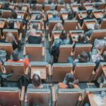 Image shows a lecture hall crowded with students