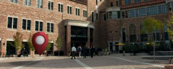 a pin drop icon overlay on an image of a campus