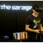 Makerspaces and Academic Incubators: A student using a virtual reality headset at the Garage