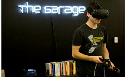 Makerspaces and Academic Incubators: A student using a virtual reality headset at the Garage