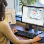 woman with a headset participating in an Academic Impressions webcast