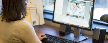 woman with a headset participating in an Academic Impressions webcast