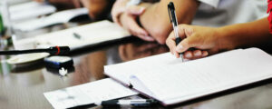 panelists taking notes during a meeting