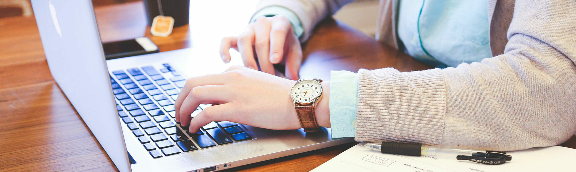 person typing on a laptop