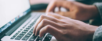 person typing on a laptop