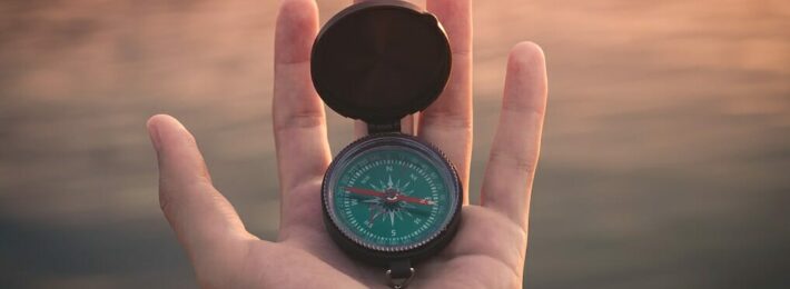 Habits of Highly Effective Higher Ed Professionals - Image of Hand Holding Compass