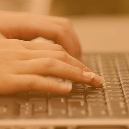 person typing on a laptop