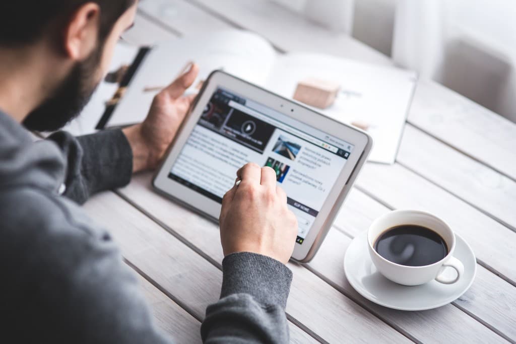 man reading a video course on a tablet