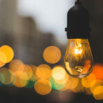 Volunteer management inspiration: Image of a light bulb on a street with a warm glow.