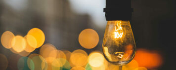 Volunteer management inspiration: Image of a light bulb on a street with a warm glow.