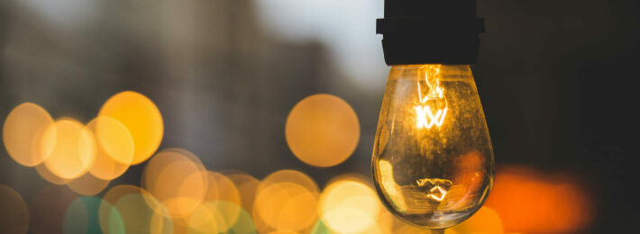 Volunteer management inspiration: Image of a light bulb on a street with a warm glow.