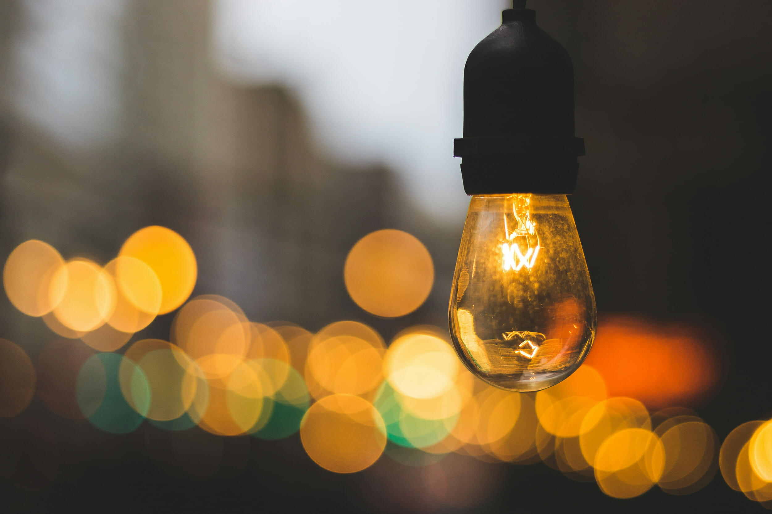 Volunteer management inspiration: Image of a light bulb on a street with a warm glow.