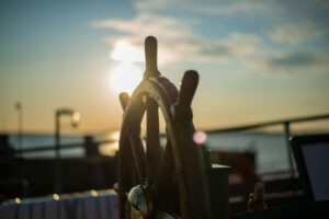 wheel of a ship in the sunset