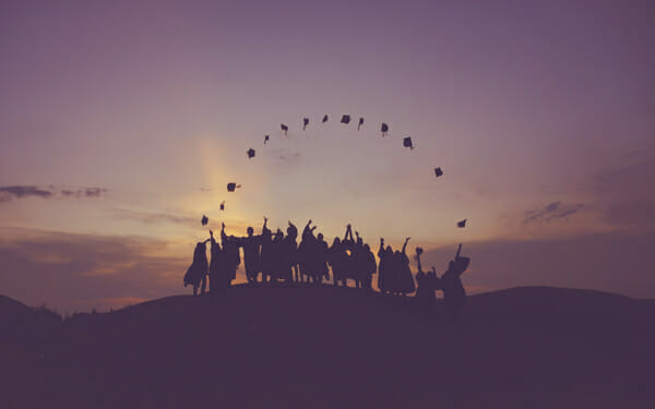 graduating students throwing caps