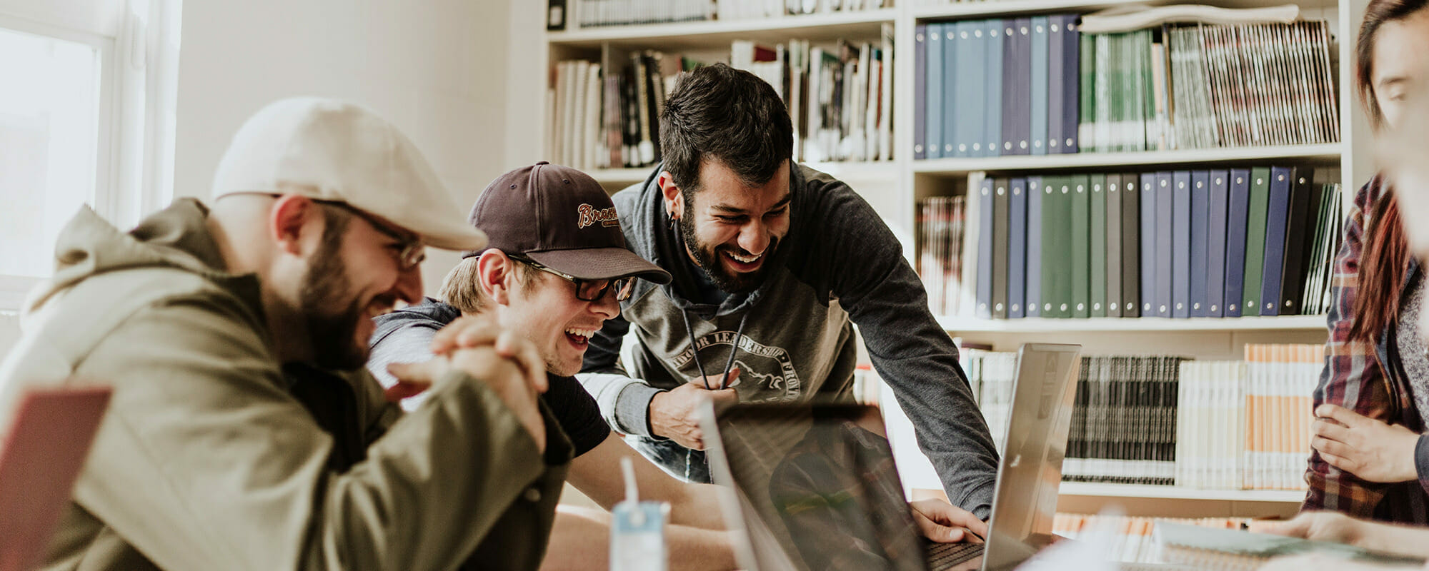 students laughing while using computers