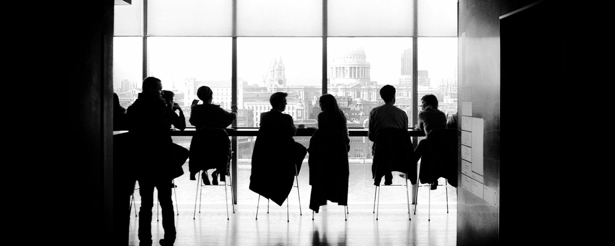 black and white image of students studying on a modern campus