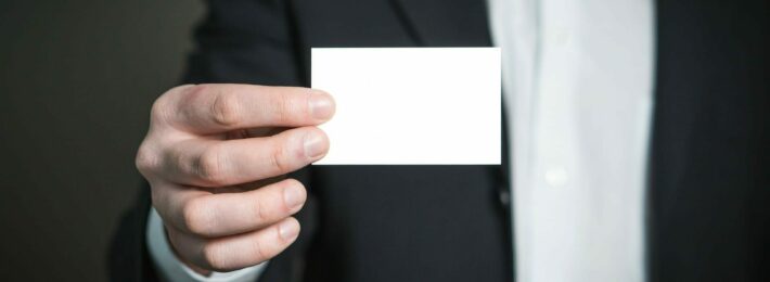 person holding a blank business card
