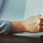 woman holding a pen over a clipboard