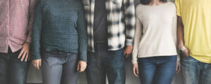 group of diverse students standing shoulder to shoulder and faces have been cropped from the photo