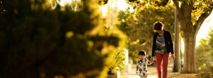 Title IX Reasonable Accommodations - Student Parent Walking with a Child on a Sidewalk