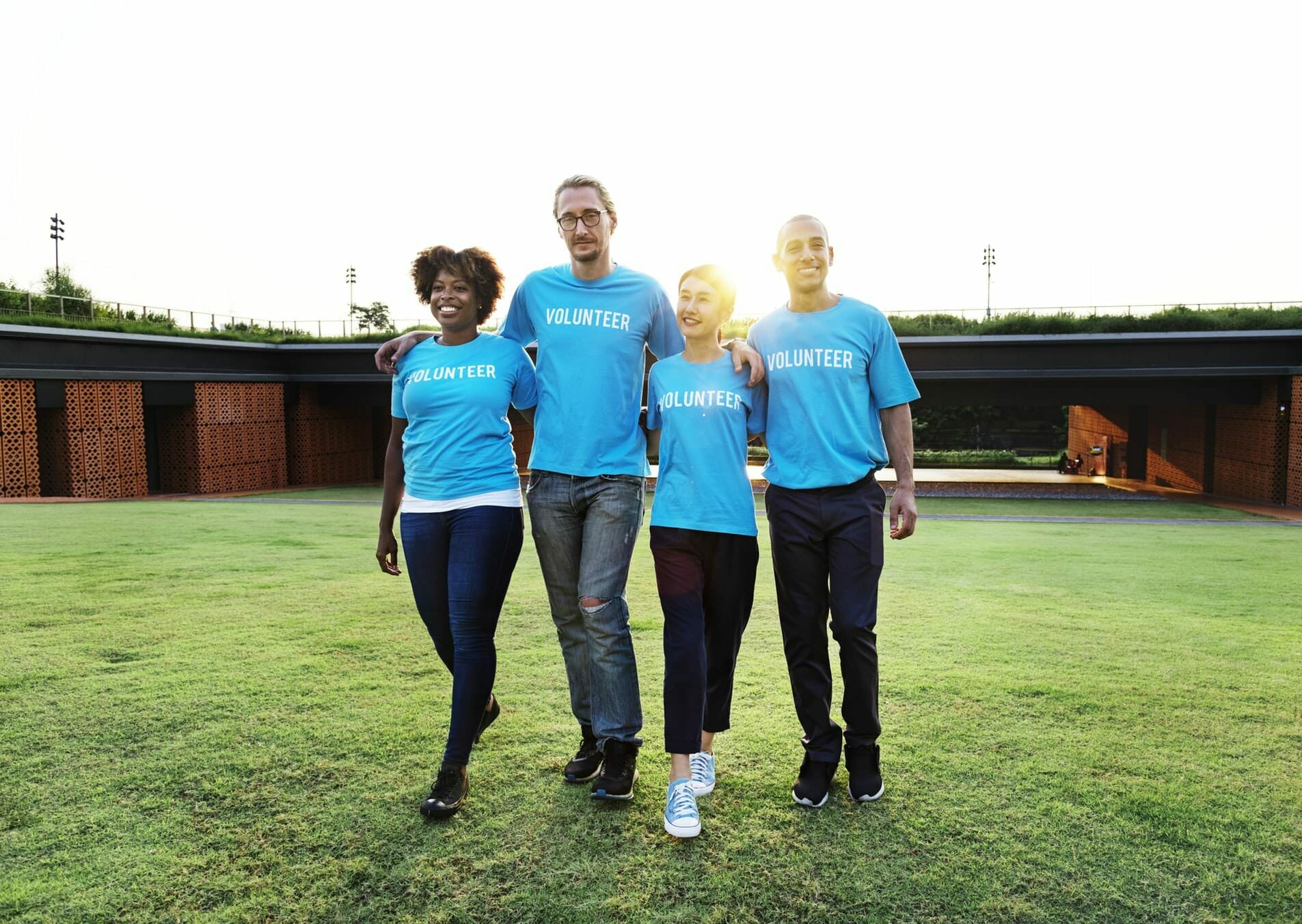 Alumni volunteer engagement: Image of four alumni volunteers in blue 