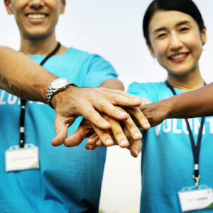 "Huddle up" hands together image for volunteers