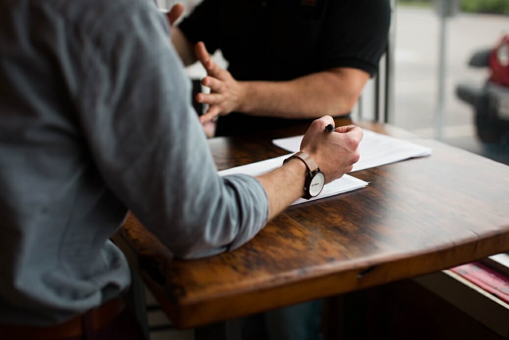 Workplace Bullying in Higher Education - Image of two colleagues arguing at a table