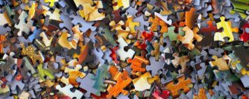 a pile of small puzzle pieces fills the entire frame of the photo