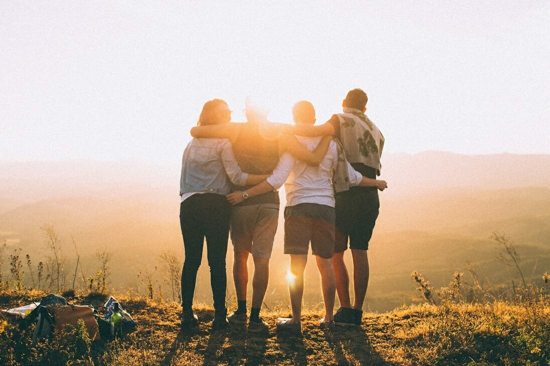Developing Student Leaders - Image of Four Students Facing a Sunset Together