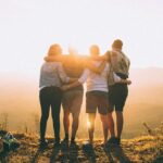 Student Leadership Development - Image of Four Students Facing a Sunset Together
