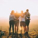 Student Leadership Development - Image of Four Students Facing a Sunset Together