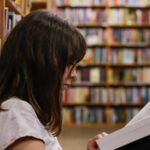 First Generation Students: Image of a woman reading at an academic library