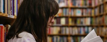 First Generation Students: Image of a woman reading at an academic library