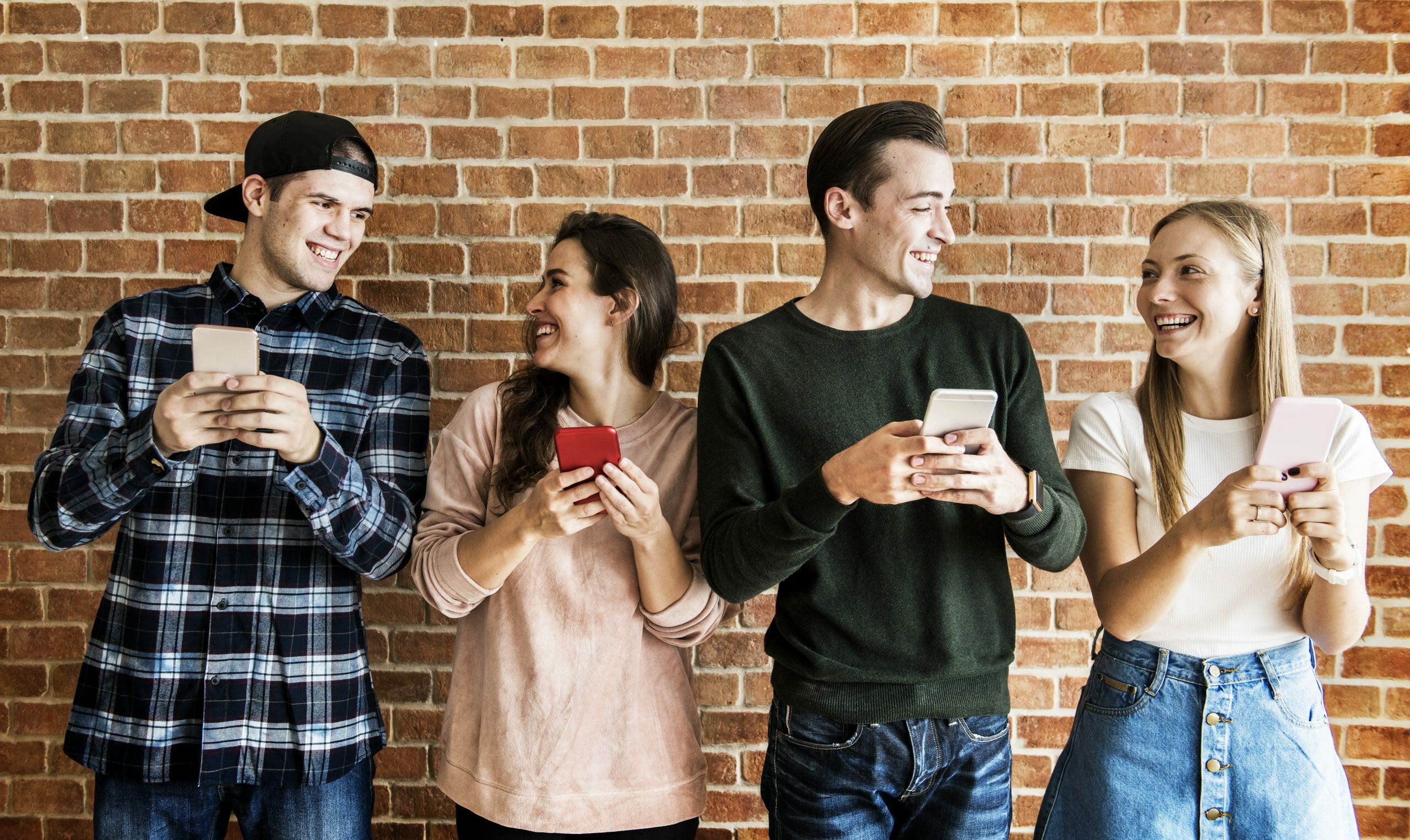 Happy friends using smartphones social media concept