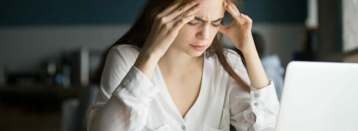 Nervous stressed woman feeling anxiety or strong headache massaging temples studying in cafe, young tired female student experiencing panic attack preparing for test or exam in public place