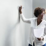 Woman writing on a whiteboard