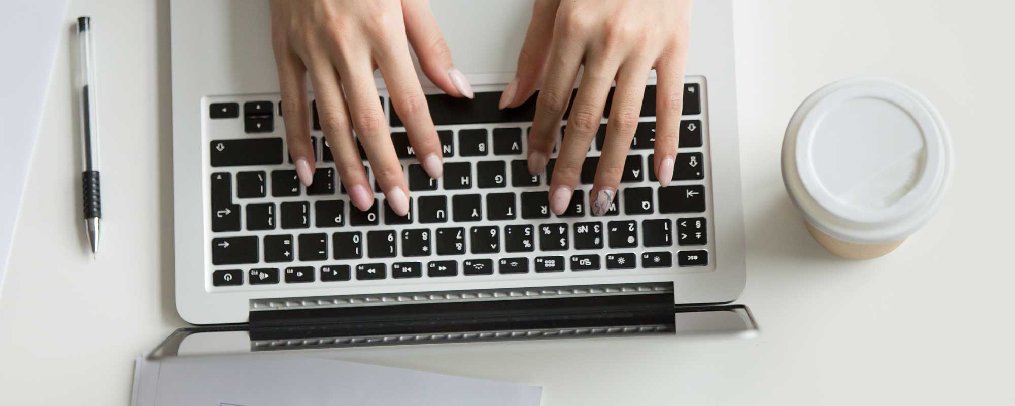 Person typing on a laptop keyboard