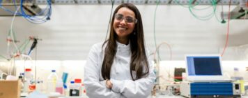 Image of a smiling researcher in a chemical engineering lab