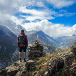 Photo of a person in the mountains gazing toward the future