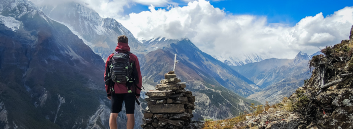 Photo of a person in the mountains gazing toward the future