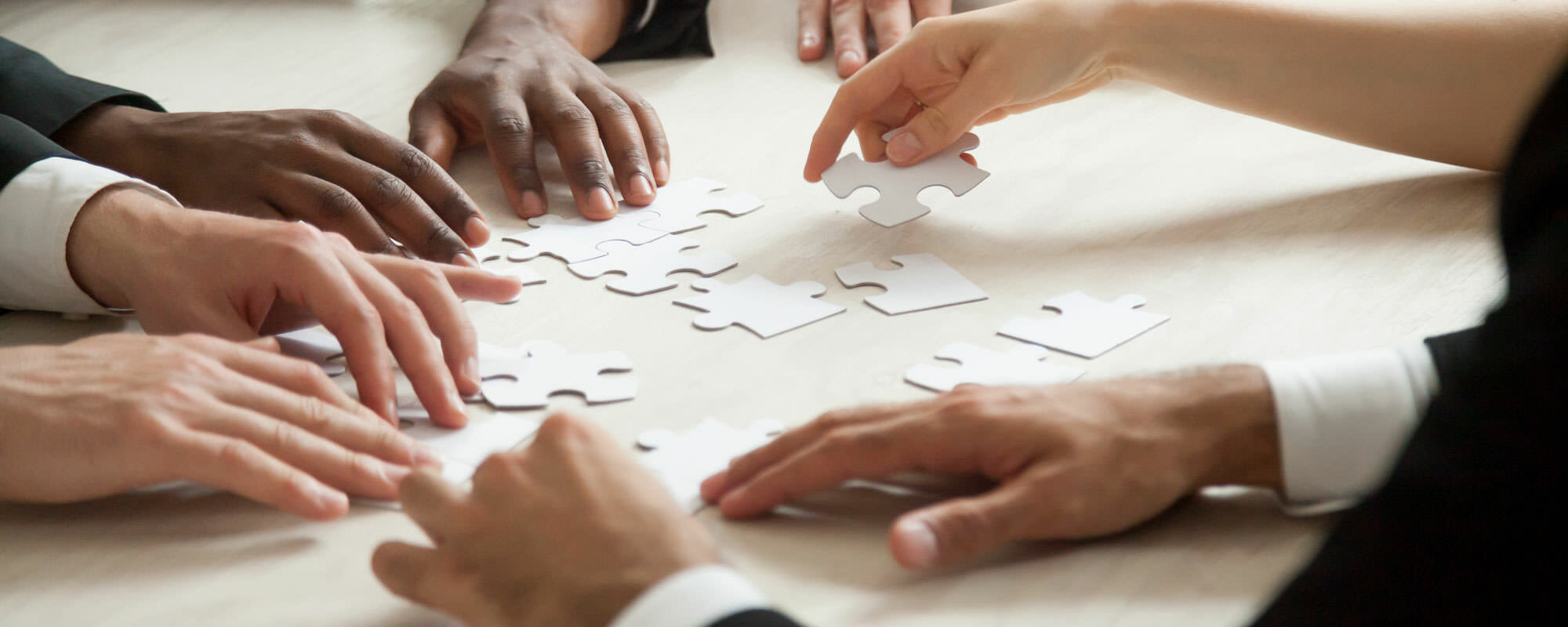 puzzle People putting a puzzle together