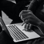 Black and white photo of a student at a laptop