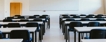 empty classroom with tables and chairs