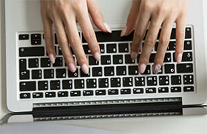 Hands typing on keyboard