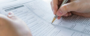 Close up of a female hand filling out an assessment form