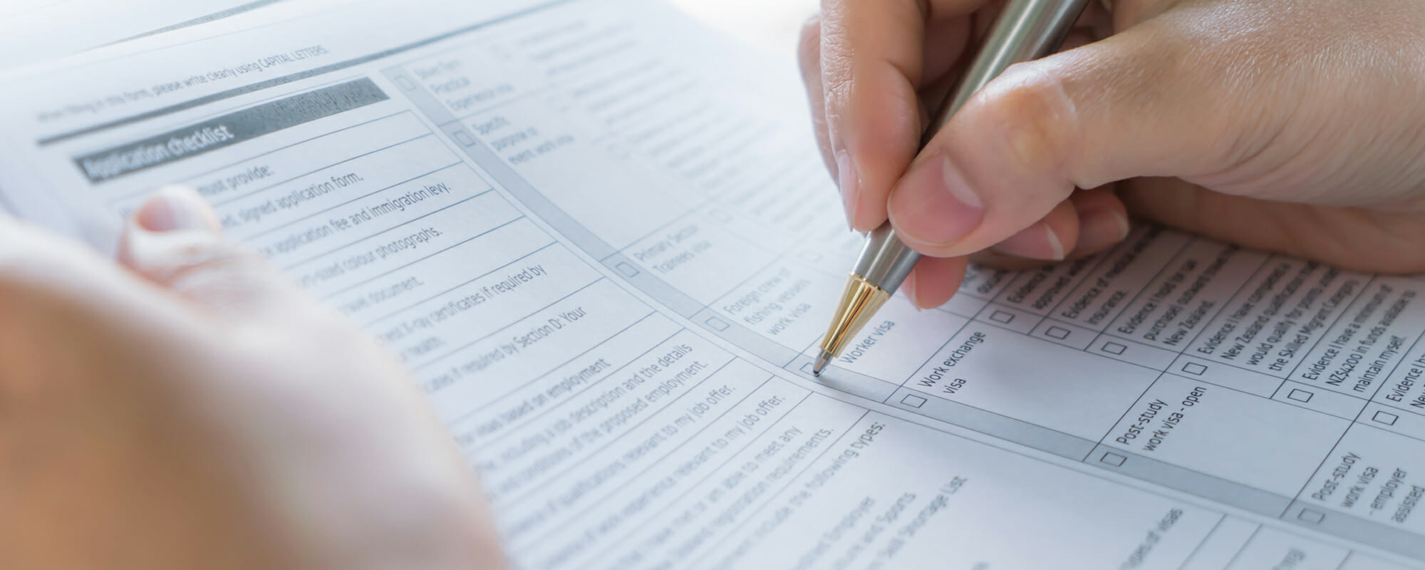 Close up of a female hand filling out an assessment form